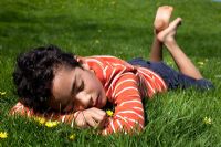 Boy asleep on grass