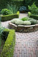 Herb parterre with low hedging and circular raised bed