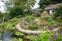Well stocked medium sized pond. Derry Watkins Garden at Special Plants, Bath, UK