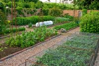 Walled kitchen garden with gravel paths, Victorian style 'rope' edging to the beds and metal obelisks - Old Rectory, Kingston, Isle of Wight, Hants, UK