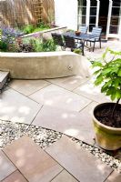 Curving limestone steps in small modern garden. 