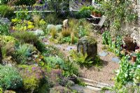 Random planting in this Devon garden, with great use of local stone, and an interesting collection of ancient garden props.  Higher Sanduck Barn, Lustleigh, Devon. July.