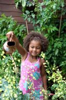 Young girl watering plants