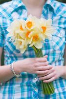 Girl holding Narcissus 'Edward Buxton'