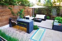 Modern garden with barbecue and dining area
