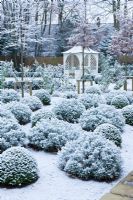 Formal town garden with gazebo covered in snow, Oxford, UK. 
