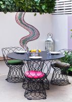Small patio garden with dining area and mosaic by Celia Gregory, London. 
