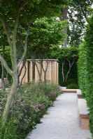 A gravel path leading to Japanese style structure 