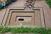 Decorative, York stone water drainage sump in 'The Art of Yorkshire garden', sponsored by Welcome to Yorkshire - RHS Chelsea Flower Show 2011