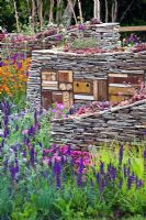 Sculptural drystone walls with built-in insect shelters and Sempervivum - Houseleeks planted on top - The Royal Bank of Canada with the RBC New Wild Garden, Silver Gilt Medal Winner - RHS Chelsea Flower Show 2011 
