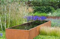 Cor-Ten steel water trough under Betula - Birch tree and surrounded by Agapanthus, Stipa tenuissima and Lavandula - 'Vestra Wealth's Gray's Garden' - RHS Hampton Court Flower Show 2011