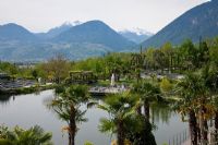 Snow covered mountain tops in the background of the botanical gardens of Trauttmansdorff Castle, Merano, Italy