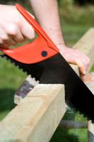 step by step, making a raised bed - cutting wood uprights