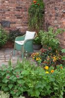 Vintage Lloyd Loom wicker chair in herb garden 