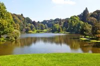 View across lake to the Palladian Bridge and the Temple of Flora at Stourhead Gardens, Wiltshire, UK, early September, Designed by Henry Hoare
 