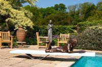 The poolside terrace, pashley manor gardens, sculpture by kate denton