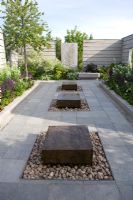Modern garden with benches made from timber and steel, materials used stone, steel, wood, clinker, and glass. Plants - Zigadenus elegans, Salvia nemorosa 'Caradonna', Chamerion angustifolium 'Album'   