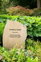 Commemorative stone to the gardener Geoffery Smith beside the stream - RHS Garden Harlow Carr, Harrogate, North Yorkshire, UK