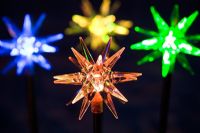 Coloured star solar powered Christmas lights at night