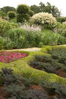 The Broughton Grange Box parterre - the design is based on the structure of leaves viewed under a microscope infilled with blocks of colour through the year with different plants depending on the season.  The infill of Buxus shows Cosmos, Antirrhinum and Kale