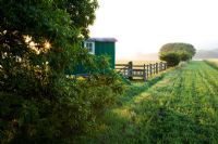 Renovated shepherd's hut in a meadow at dawn