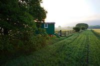 Renovated Shepherd's hut in a meadow at dawn