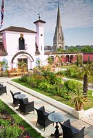 View of The Spanish Garden at The Roof Gardens, Kensington, with St. Mary Abbots Church beyond