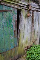Rustic old barn door with rusty found objects 