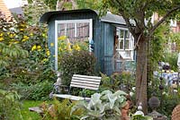 Seat in front of trailer used as a summerhouse