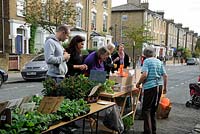 People buying plants from stall in a residental street, Hackney, London