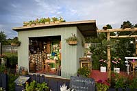 An old tin field shelter has been converted into a preserving kitchen - 'Preserving the Community' - Silver medal winner - RHS Hampton Court Flower Show 2012 
