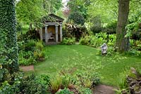 The Stumpery with the sculpture 'Goddess of the Woods' and one of two temples - Highgrove Garden, May 2008.