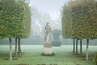 Hedges and statue. The statue is one of four goddesses representing the four seasons. These are from Italy.   
