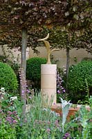 Bronze Bird sculpture by the late Breon O'Casey with pleached Fagus sylvatica 'Atropunicea' - The Laurent-Perrier Garden.