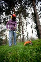Woman using a strimmer