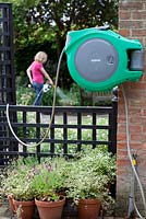 Woman using wall mounted hose