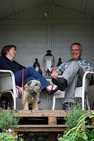 Barry and Mandy Milton in their summerhouse with their border terrier, Monty - The Lizard, Wymondham, Norfolk