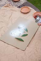 Step by step - spraying bay leaves to create labels for moss parcels