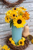 Sunflowers and Rudbeckias in blue enamel jug