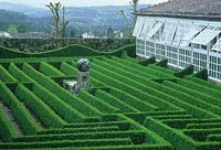 Garden maze made from box hedge with central spherical ornament 