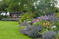 Bavarian country garden with bee house and perennial border 