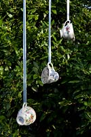 Step by step for creating hanging bird feeders out of teacups 