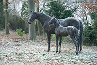 Mare and foal 'found object' sculptures by Harriet Mead with cobwebs and frost in December