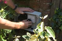 Plugging 12 volt transformer into mains socket in outside box to power garden lighting