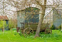 Shepherds hut and old farm cart in wild garden - The Mill House, Little Sampford, Essex