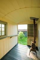 Interior of shepherds hut with pot belly stove - The Mill House, Little Sampford, Essex