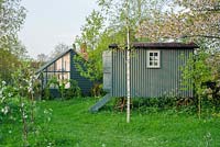 Shepherds hut in wild garden with lean-to greenhouse and garden shed - The Mill House, Little Sampford, Essex