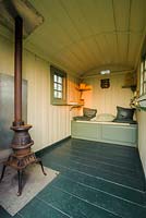 Interior of shepherds hut with pot belly stove - The Mill House, Little Sampford, Essex