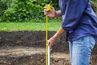 Checking the depth of the excavated area