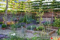 Potager in summer with raised beds and bench